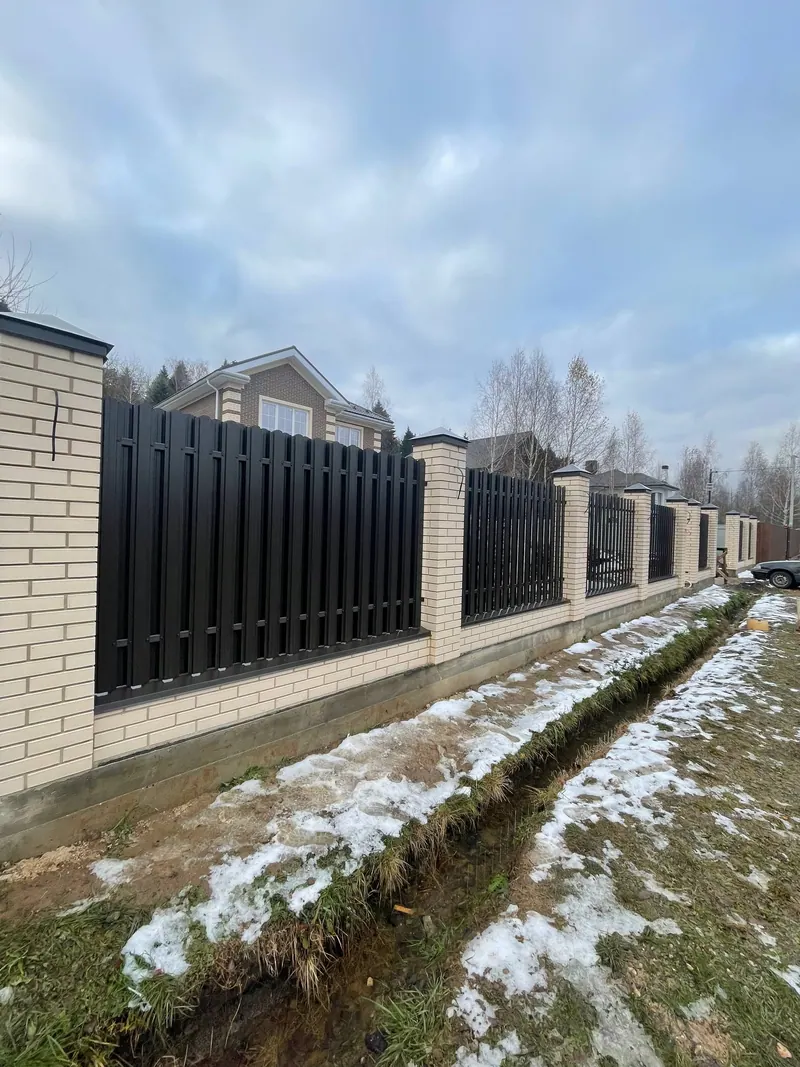 Ограждение участка: кирпичные столбы и тёмное металлическое заполнение